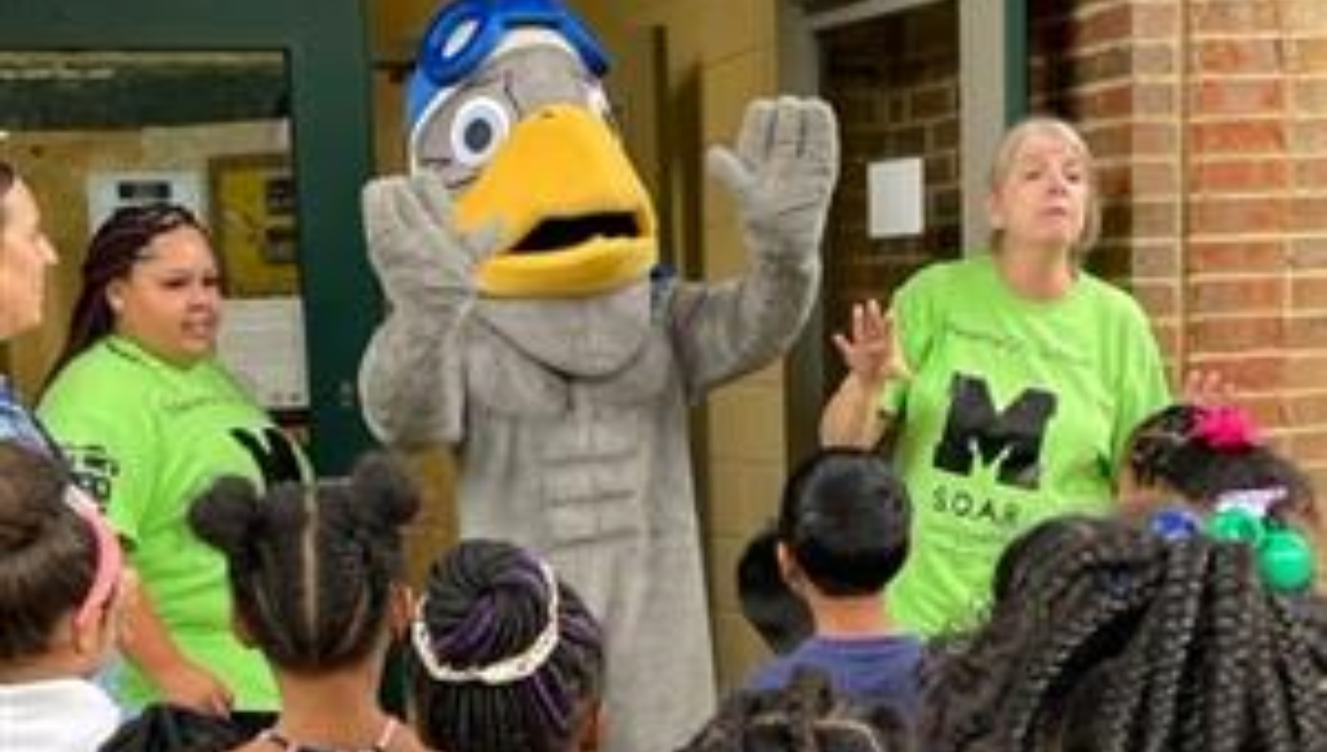  SOAR Mascot waving to school children